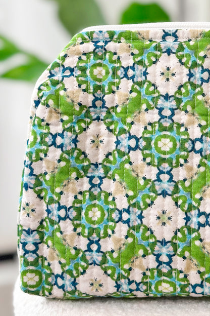 Fabric pouch with green and blue pattern on a white background