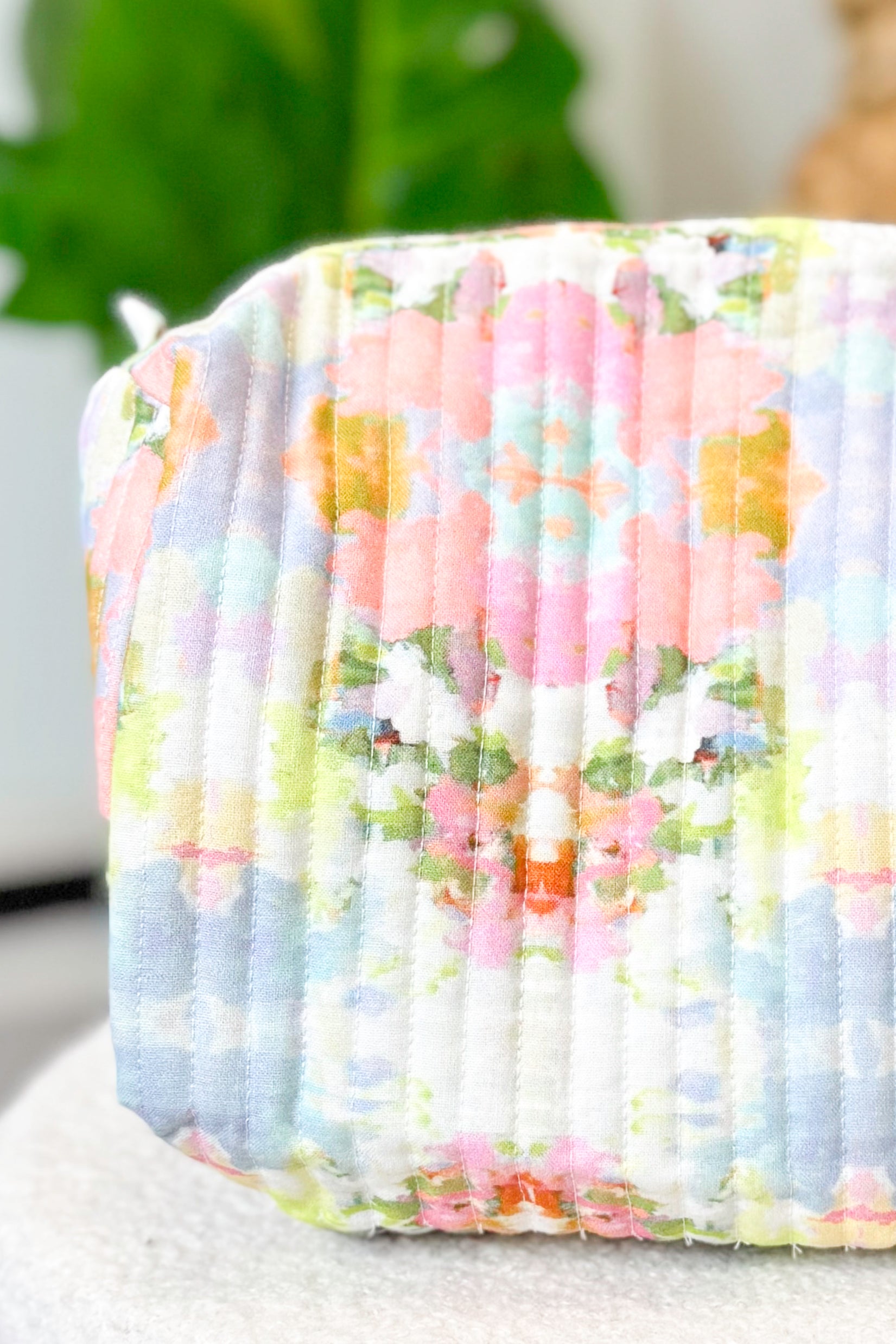 Floral patterned fabric roll with pastel colors on a neutral background