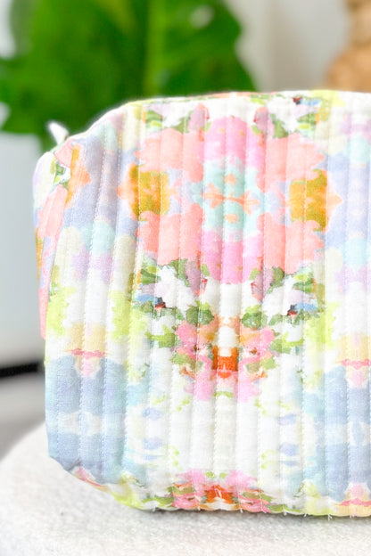 Floral patterned fabric roll with pastel colors on a neutral background