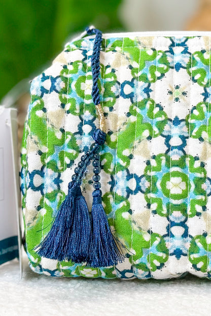 Decorative box with floral pattern and blue tassel on a white surface
