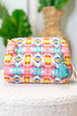 Colorful woven pouch with a tassel on a white surface with a blurred background