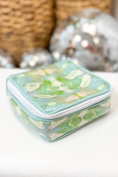 Clear cosmetic bag with floral pattern on a white surface
