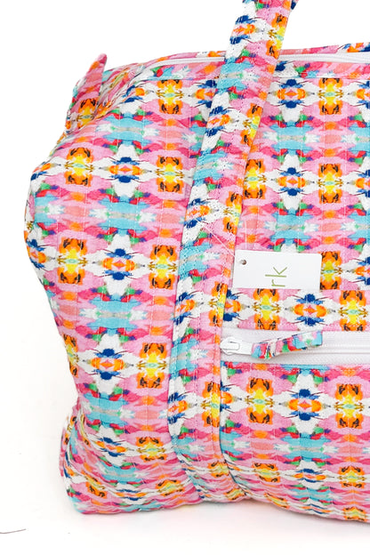 Multicolored patterned bag with a visible brand logo on a white background