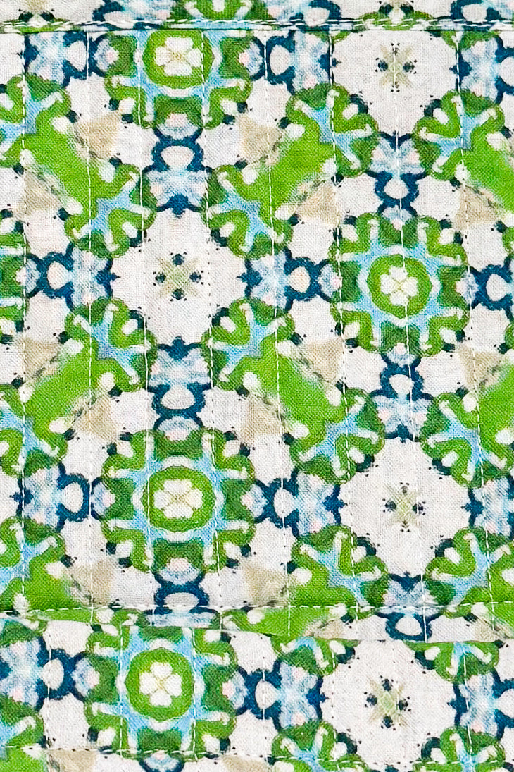 Patterned fabric with green, blue, and white colors