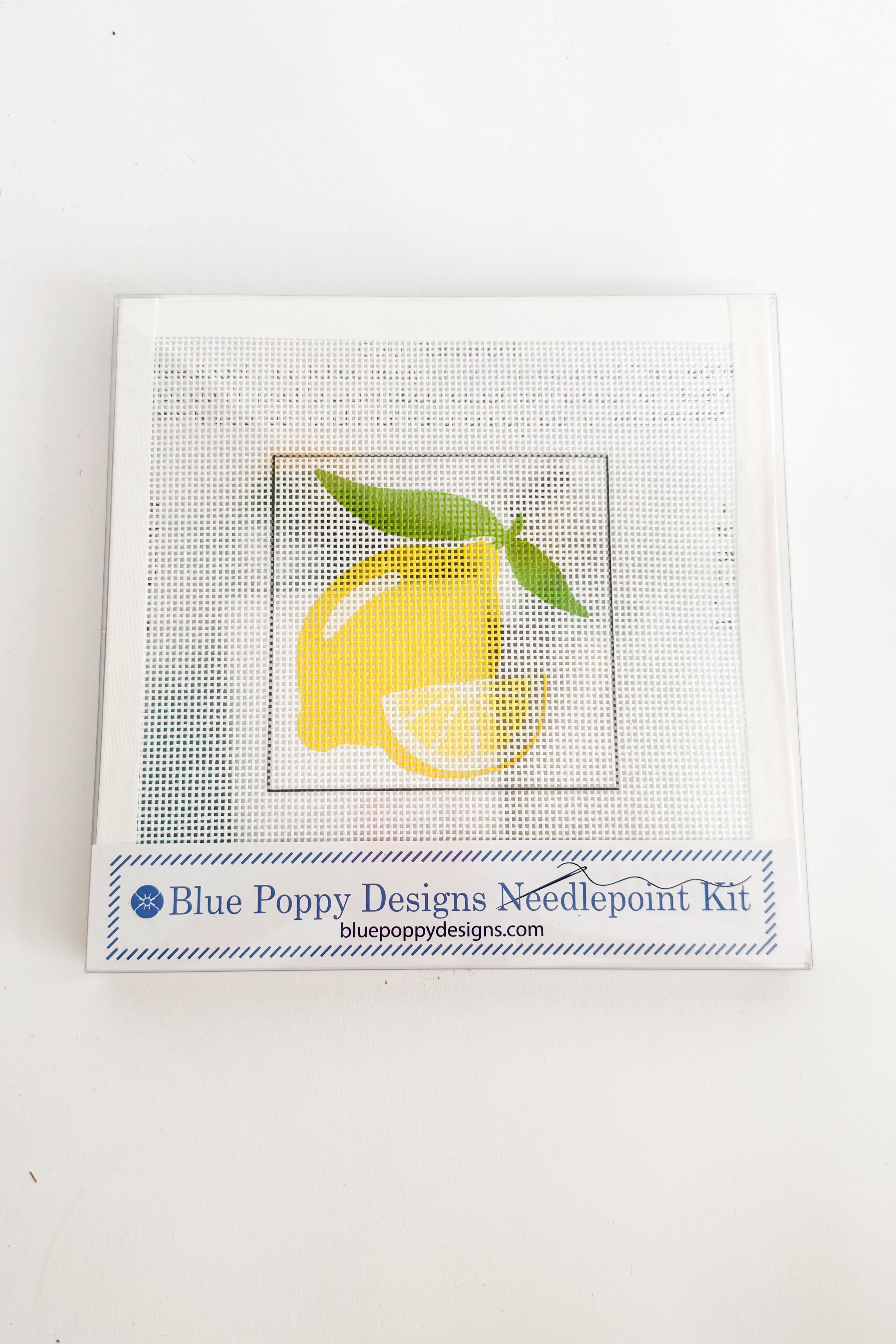 Cross-stitch kit with a lemon design on a white background