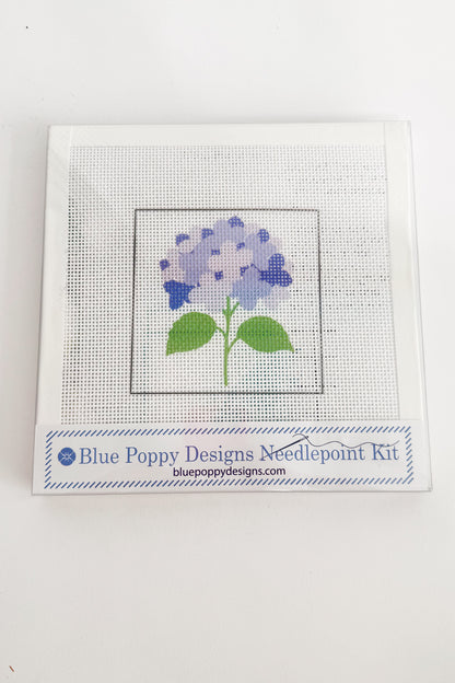 Needlepoint kit with a blue flower design on a white background
