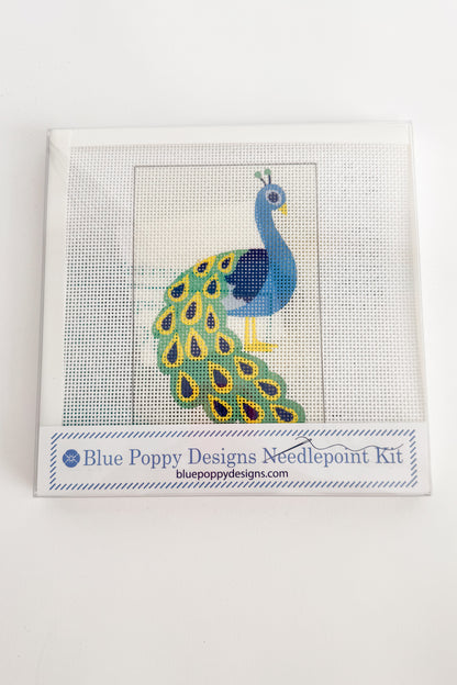 Cross-stitch kit with peacock design on a white background