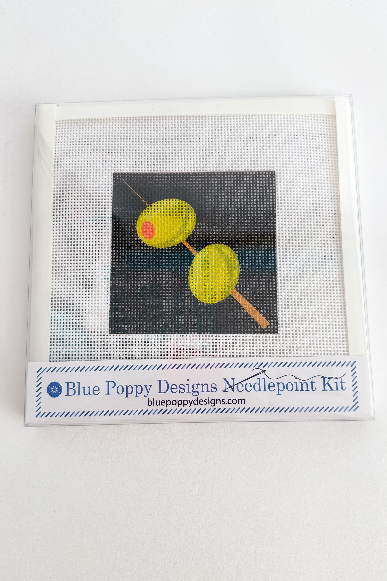 Blue Poppy Designs needlepoint kit with a sample of completed work on a white background