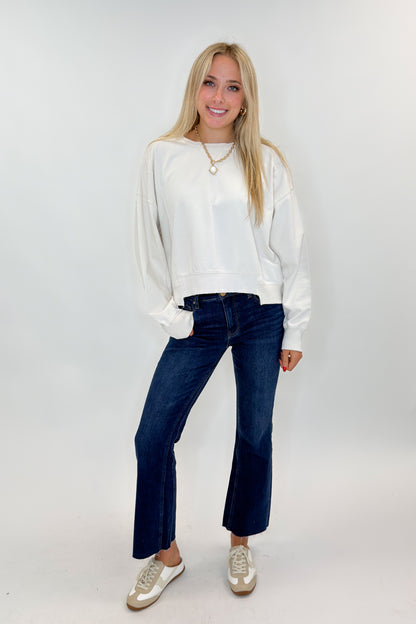 Front view of woman wearing Swagger Boutique’s Kelsey Ankle Flare Jeans In Dark Wash- Improve by Kut from the Kloth with top against white studio background.