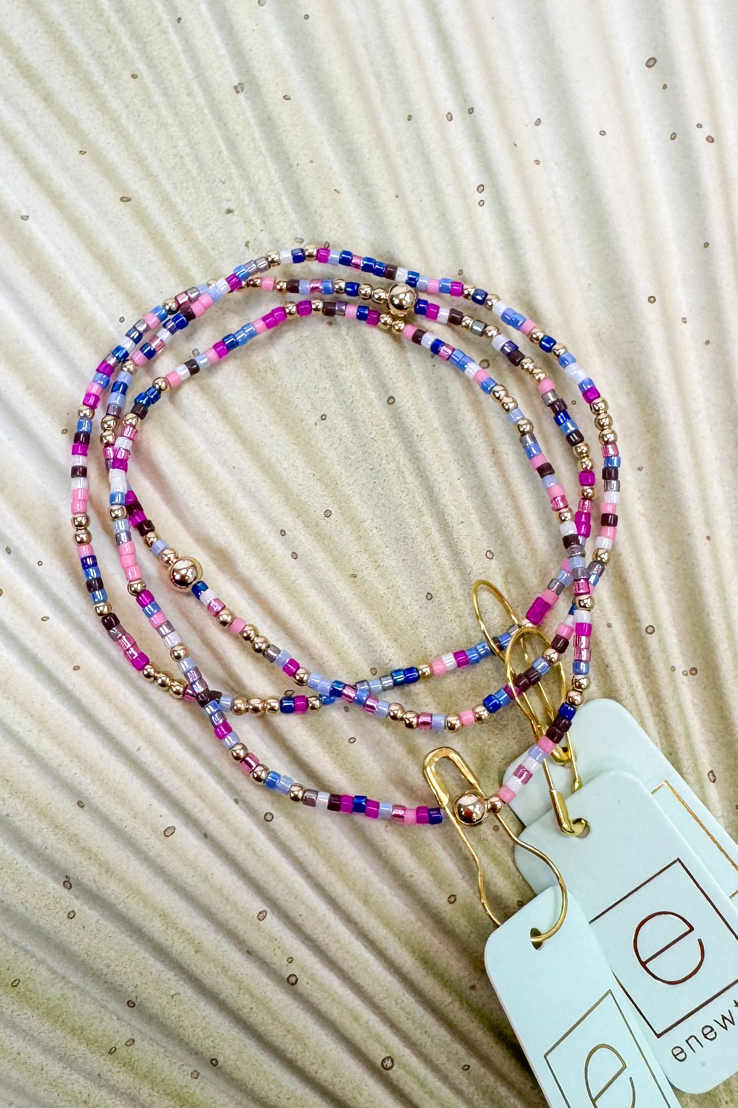 Colorful beaded bracelet on a textured beige background