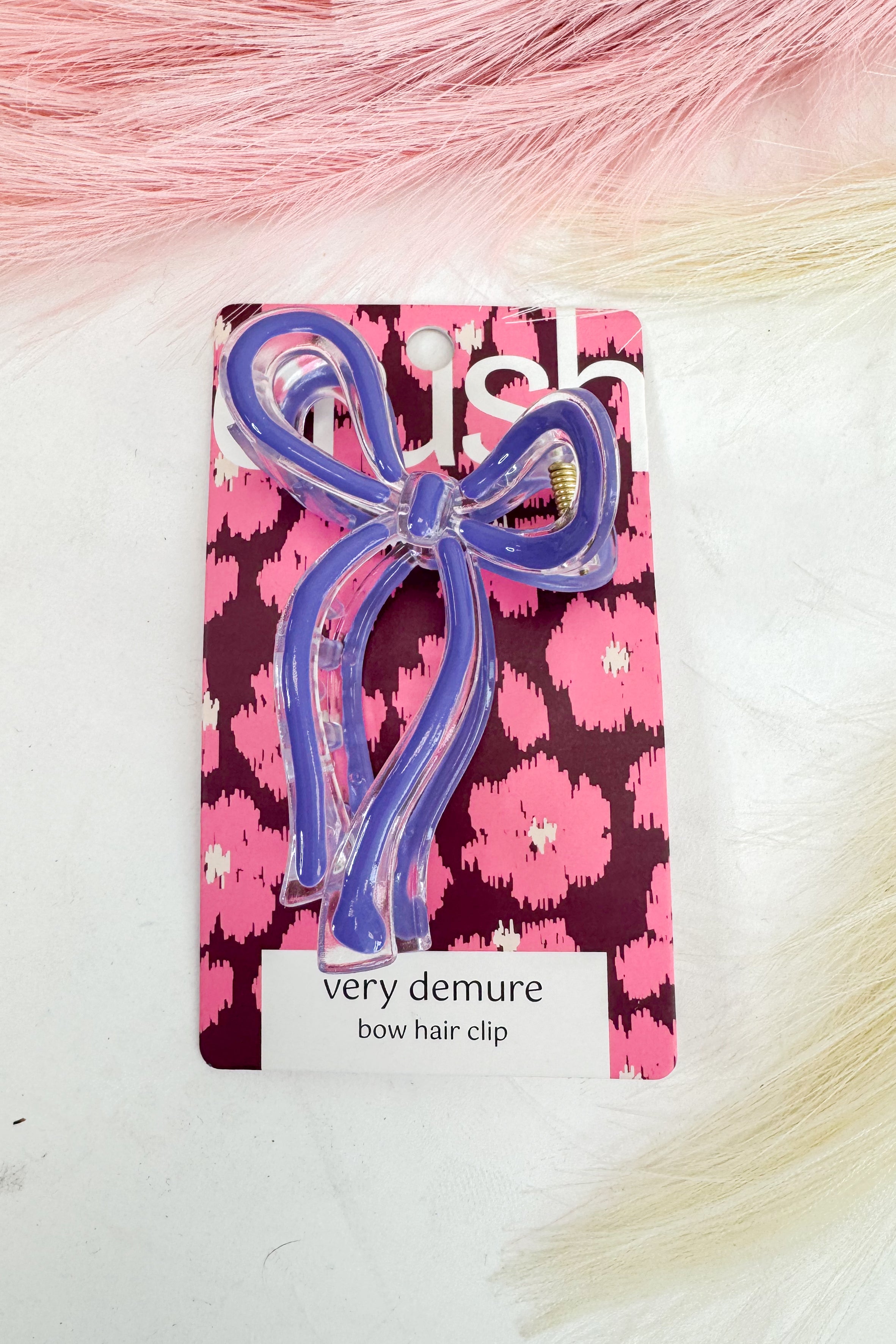 purple bow hair clip on a pink floral card with &