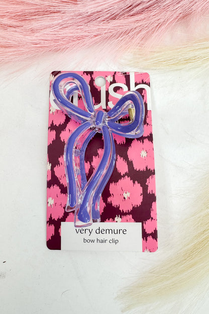 purple bow hair clip on a pink floral card with &