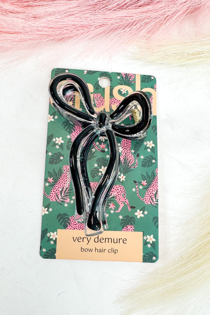 Bow hair clip on a decorative card with floral and animal print