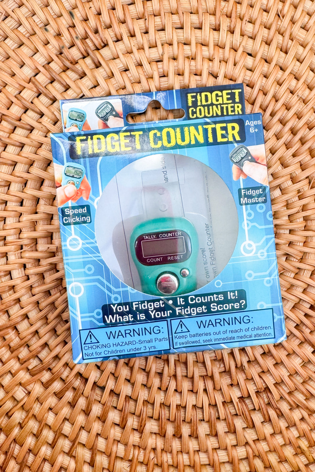 Fidget Counter packaging on a woven surface
