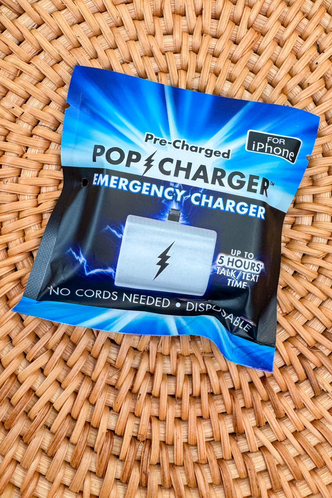 Pre-charged pop charger packaging on a woven surface