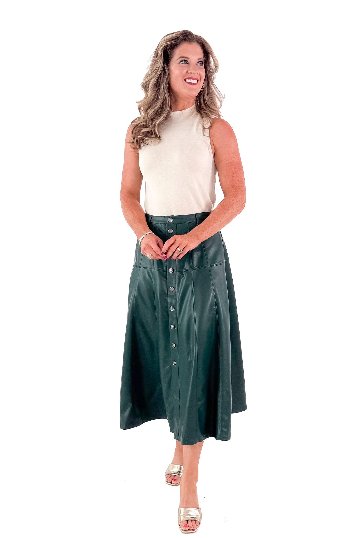 Front view of woman wearing Hunter Green Faux Leather Midi Skirt with top against white studio background.