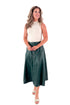 Front view of woman wearing Hunter Green Faux Leather Midi Skirt with top against white studio background.