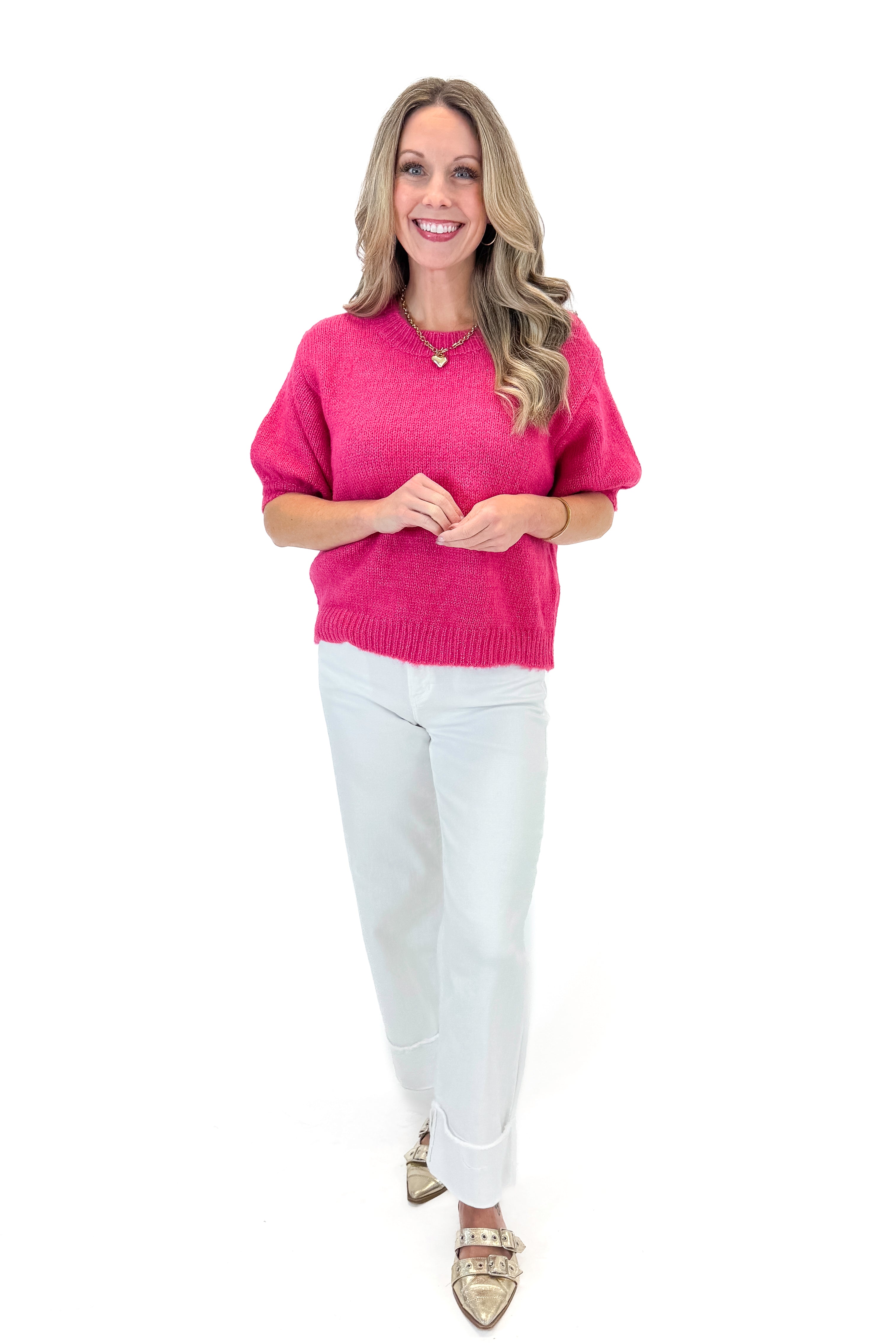 Front view of woman wearing Hot Pink Short Puff Sleeve Sweater with jeans against white studio background.
