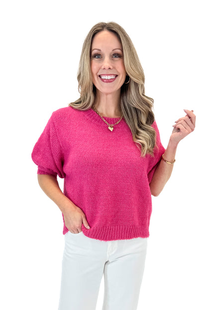 Front view of woman wearing Hot Pink Short Puff Sleeve Sweater with jeans against white studio background.