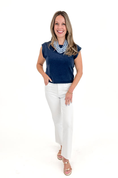 Front view of woman wearing Indigo Camino Jersey Denim Top by Z Supply with jeans against white studio background.