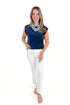 Front view of woman wearing Indigo Camino Jersey Denim Top by Z Supply with jeans against white studio background.
