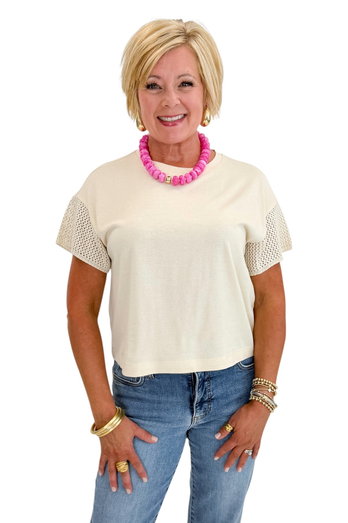 Front view of woman wearing Swagger Boutique’s Island Coconut Banyan Top by Z Supply with jeans against white studio background.