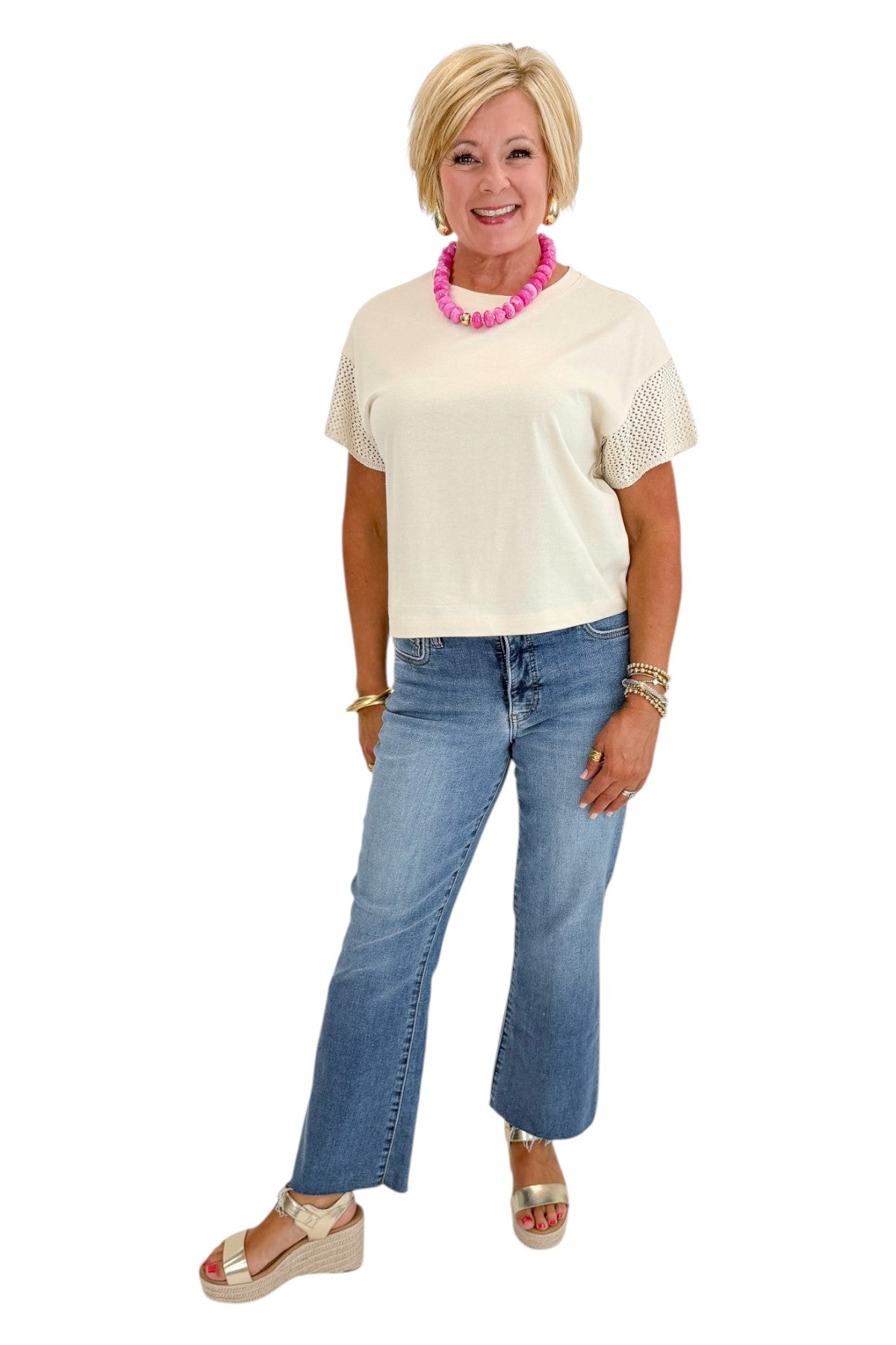Front view of woman wearing Swagger Boutique’s Island Coconut Banyan Top by Z Supply with jeans against white studio background.