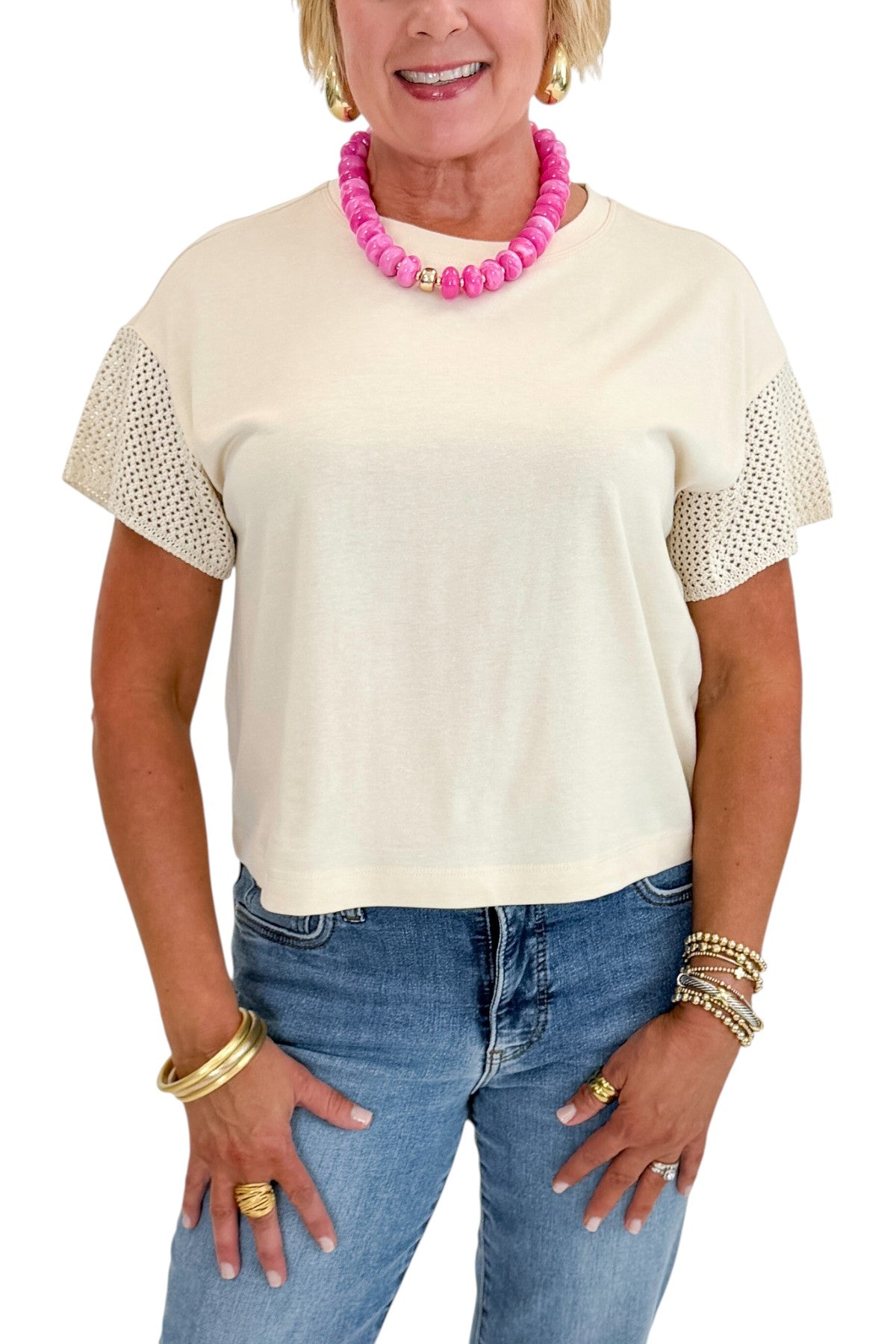 Front detail view of woman wearing Swagger Boutique’s Island Coconut Banyan Top by Z Supply with jeans against white studio background.
