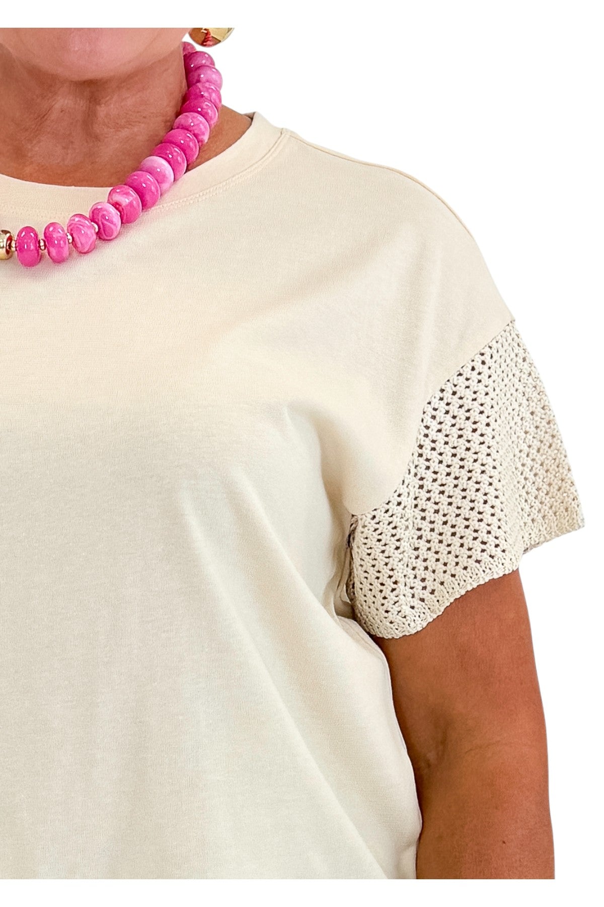 Front detail view of woman wearing Swagger Boutique’s Island Coconut Banyan Top by Z Supply with jeans against white studio background.