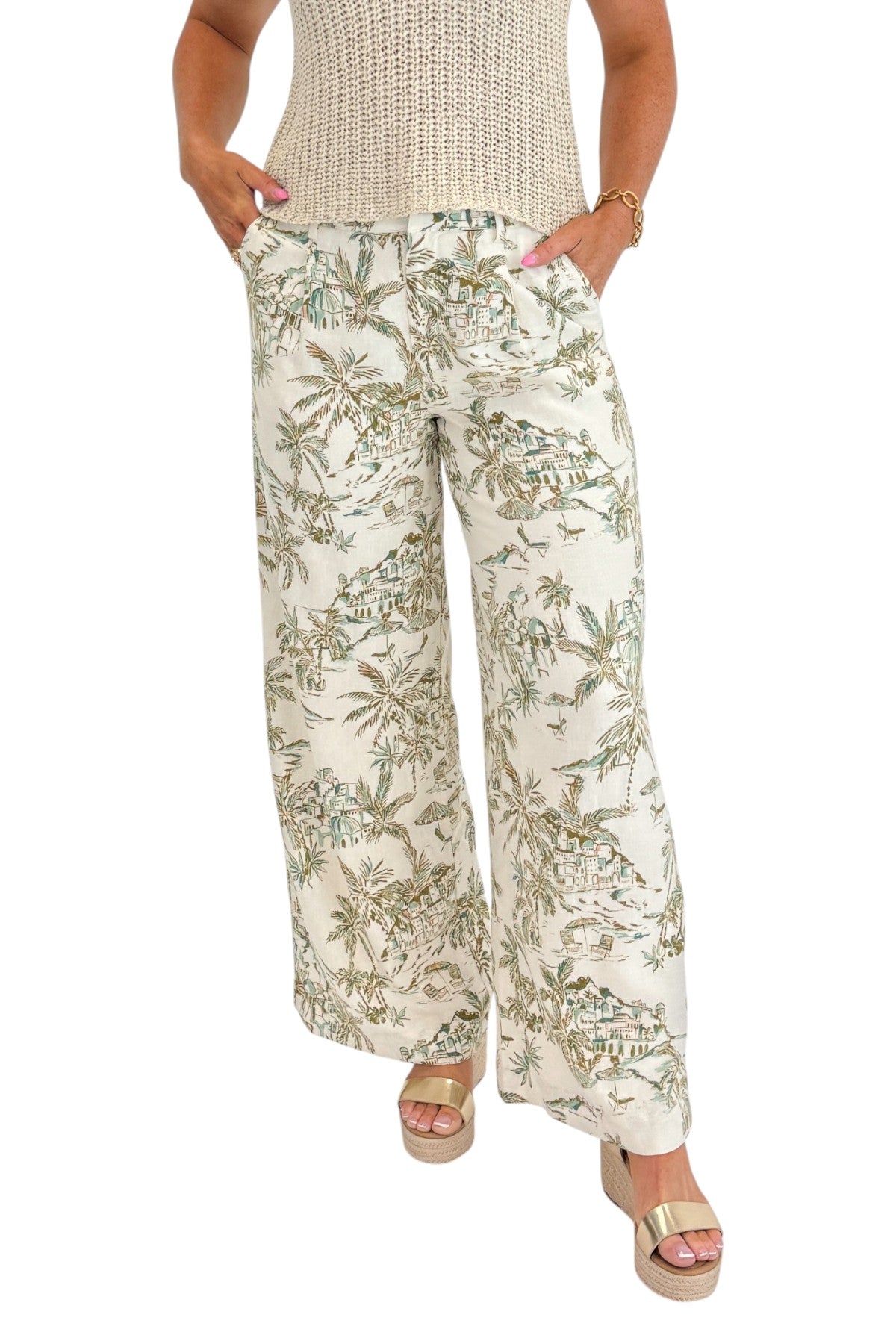 Front detail view of woman wearing Swagger Boutique’s Island Coconut Overlook Tiki Tide Linen Pants with Beige V-Neck Knitted Tank by Skies Are Blue against white studio background.