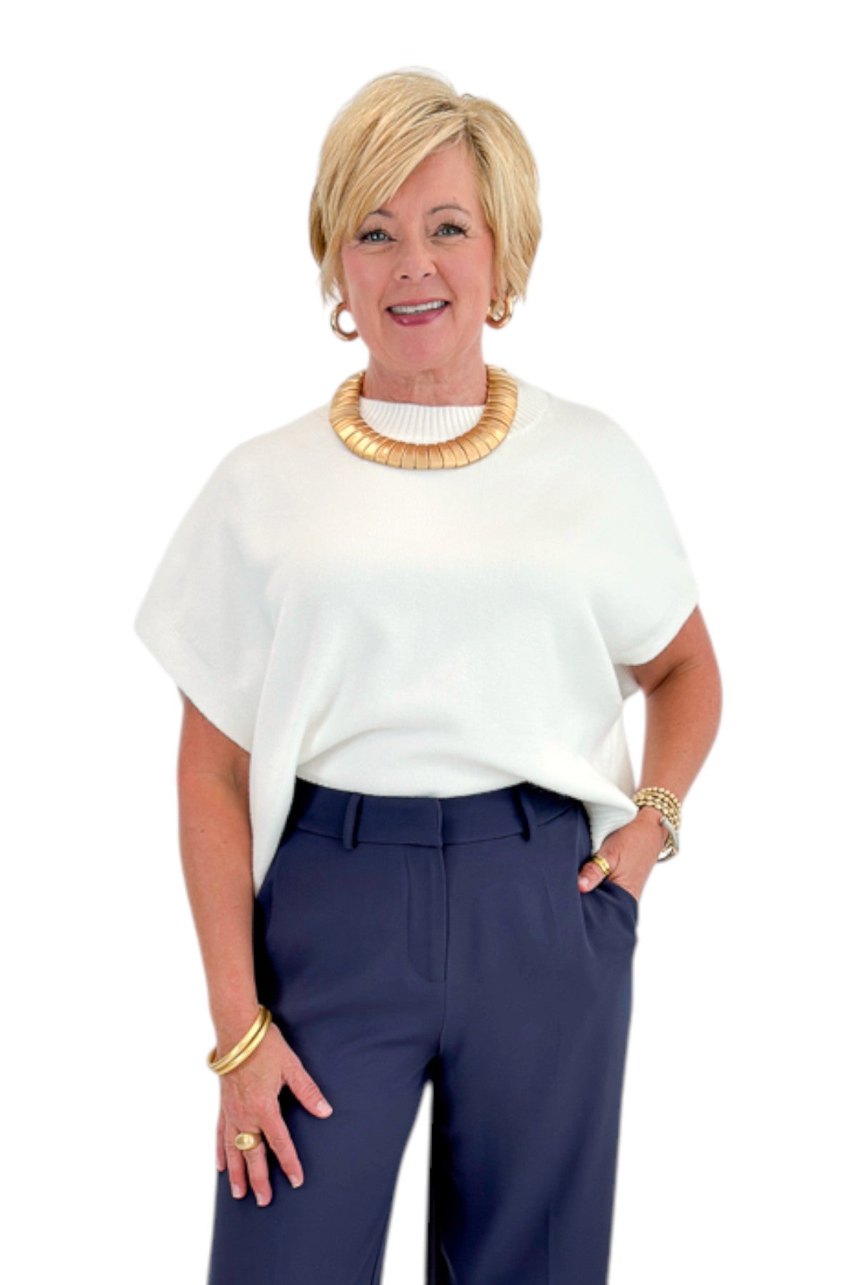 Front view of woman wearing Swagger Boutique’s Ivory Light Weight Short Sleeve Sweater with jeans against white studio background.