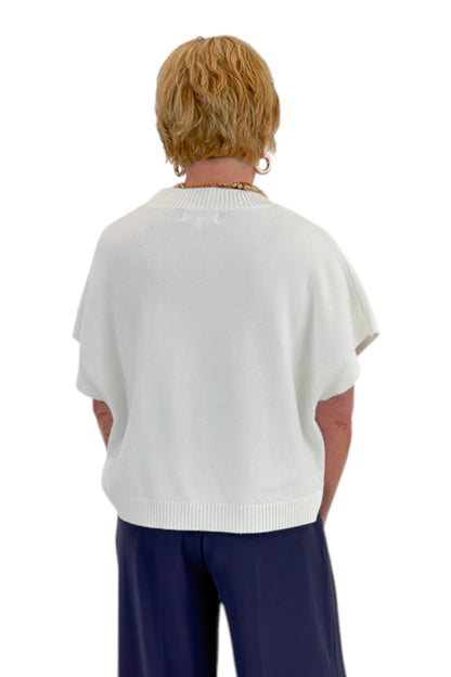 Back view of woman wearing Swagger Boutique’s Ivory Light Weight Short Sleeve Sweater with jeans against white studio background.