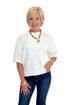 Front view of woman wearing Swagger Boutique’s Ivory Short Sleeve Sweater with jeans against white studio background.