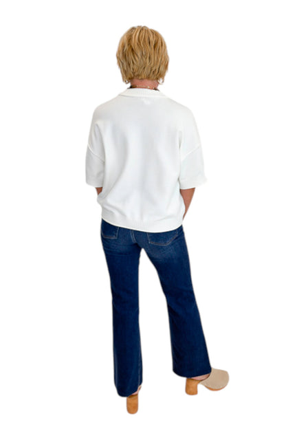 Back view of woman wearing Swagger Boutique’s Ivory Short Sleeve Sweater with jeans against white studio background.