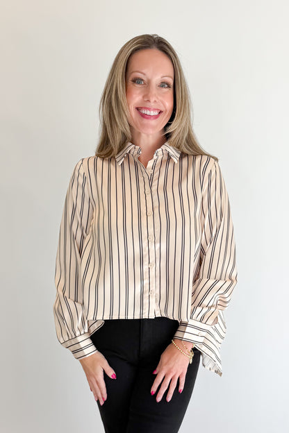 Front view of woman wearing Swagger Boutique’s Ivory &amp; Black Striped Satin Top with jeans against white studio background.
