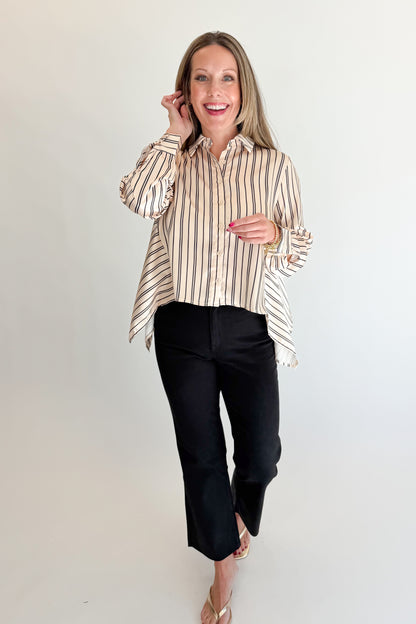 Front view of woman wearing Swagger Boutique’s Ivory &amp; Black Striped Satin Top with jeans against white studio background.