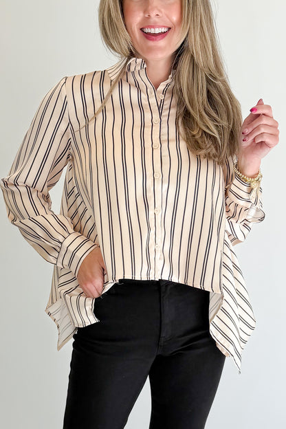 Front detail view of woman wearing Swagger Boutique’s Ivory &amp; Black Striped Satin Top with jeans against white studio background.