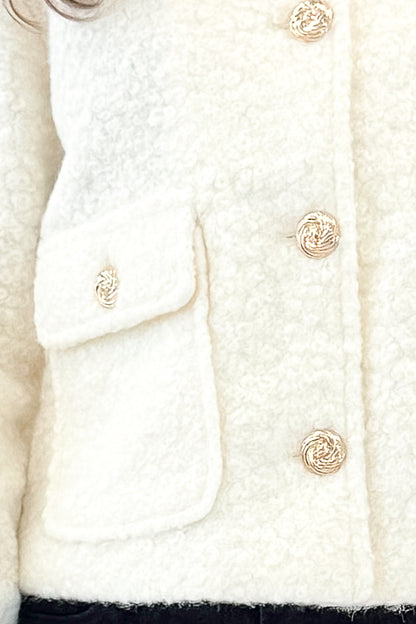 Front detail view of woman wearing Cream Sherpa Button Up Jacket with jeans against white studio background.