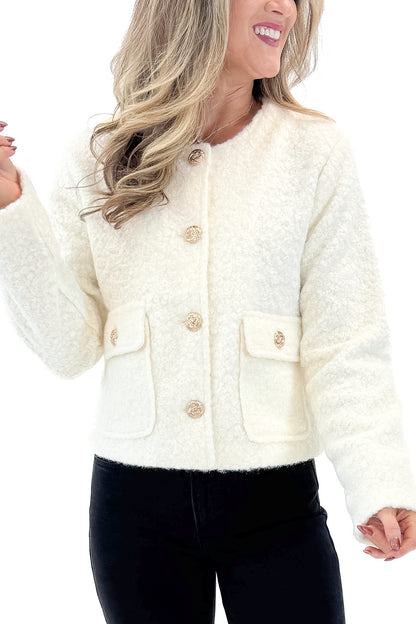 Front view of woman wearing Cream Sherpa Button Up Jacket with jeans against white studio background.