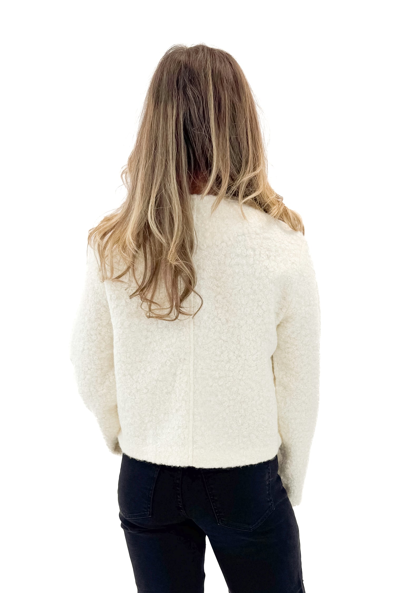 Back view of woman wearing Cream Sherpa Button Up Jacket with jeans against white studio background.