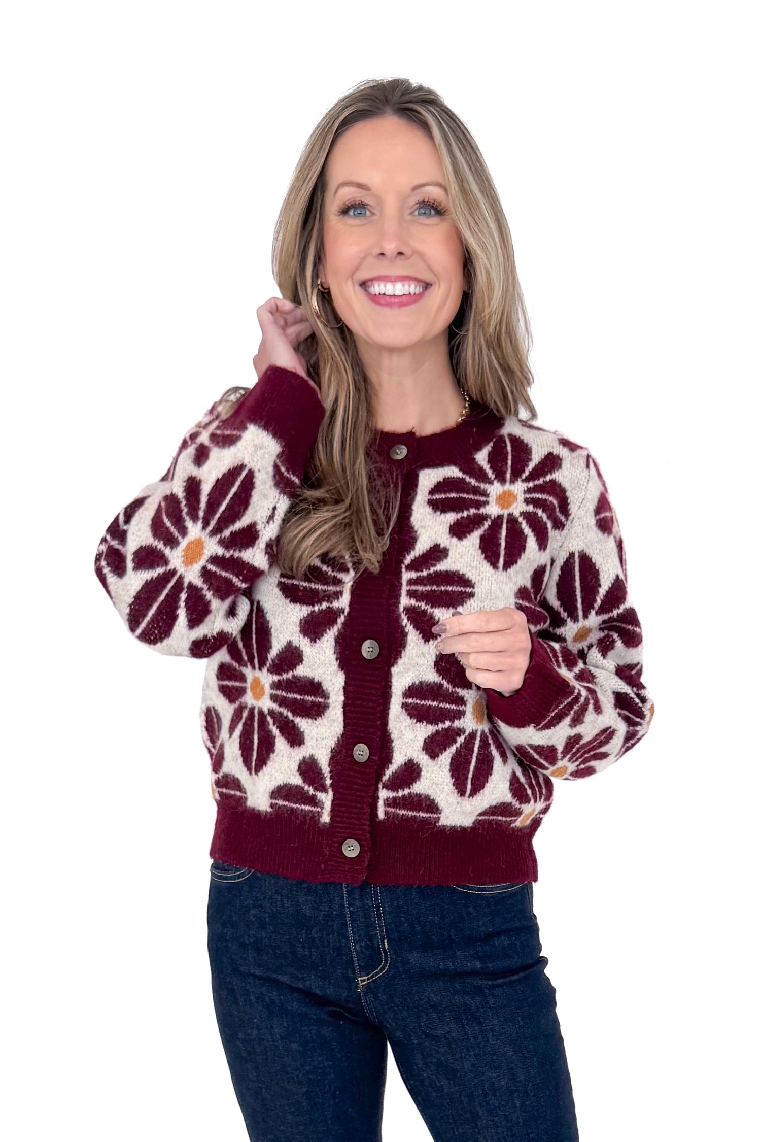 Front view of woman wearing Wine Floral Printed Button Up Cardigan by Entro with jeans against white studio background.
