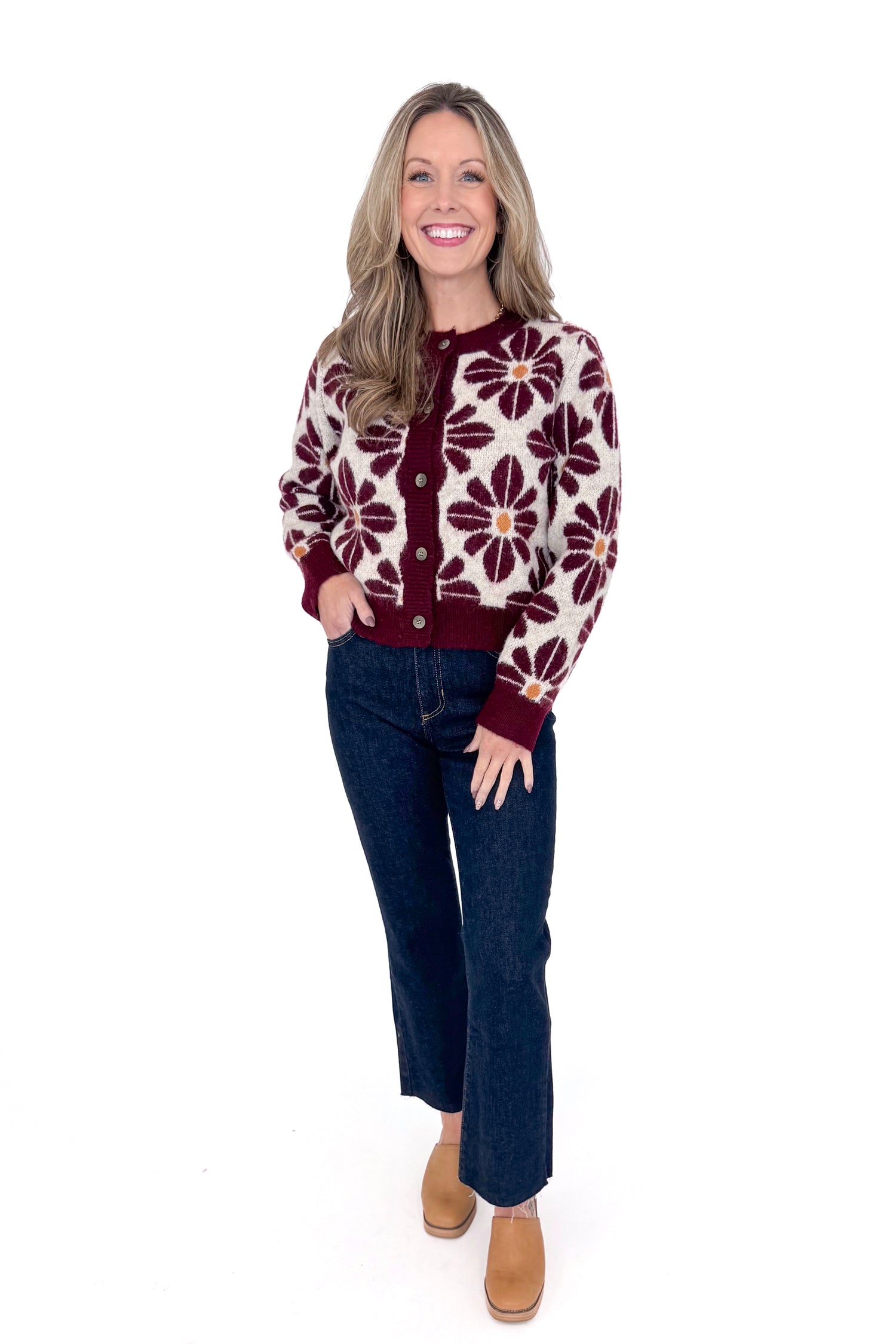 Front view of woman wearing Wine Floral Printed Button Up Cardigan by Entro with jeans against white studio background.