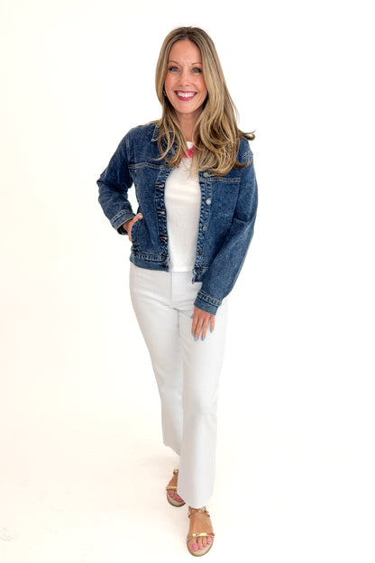 Front view of woman wearing Dark Wash Denim Jacket with jeans against white studio background.