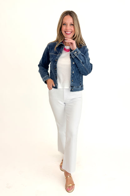 Front view of woman wearing Dark Wash Denim Jacket with jeans against white studio background.