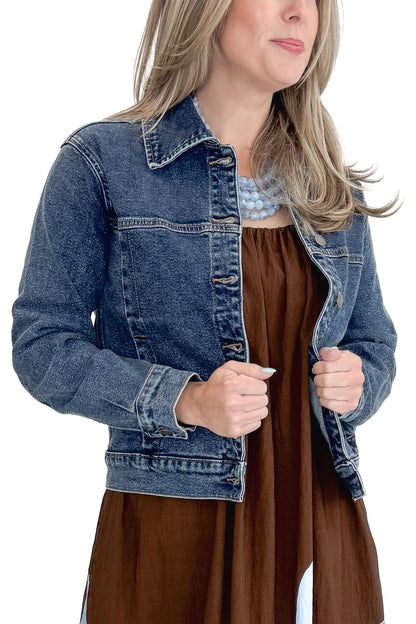 Front view of woman wearing Dark Wash Denim Jacket with brown dress against white studio background.