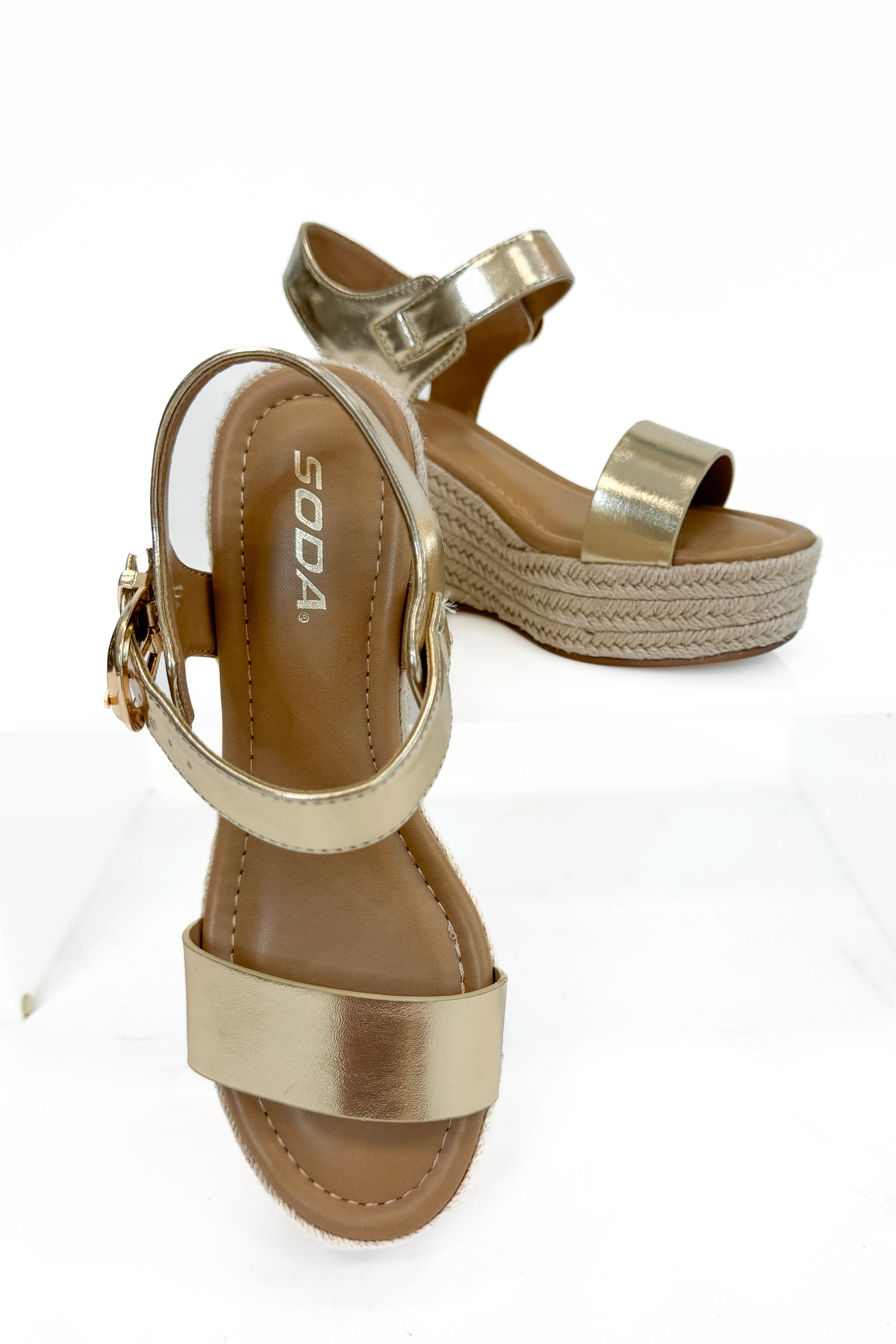 Jena Gold and Rattan Wedge shoes against white studio background.