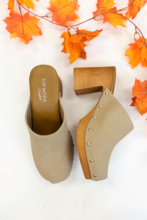 Jungle- Beige Studded Clogs against studio background