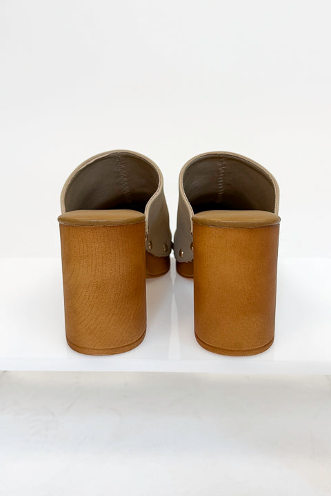 Jungle- Beige Studded Clogs against studio background back view