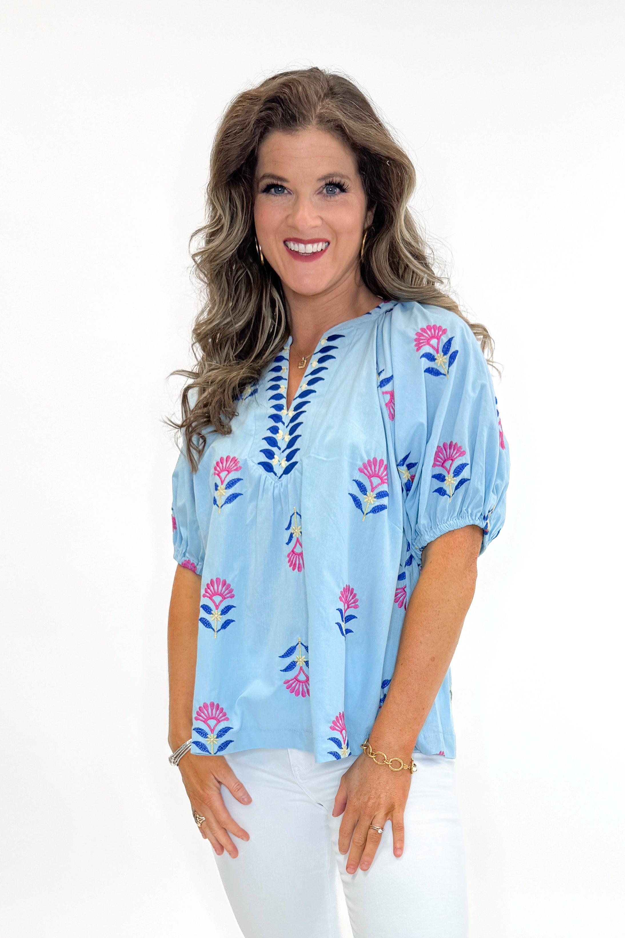 Front view of woman wearing Blue &amp; Multi Floral Embroidered Top with jeans against white studio background.