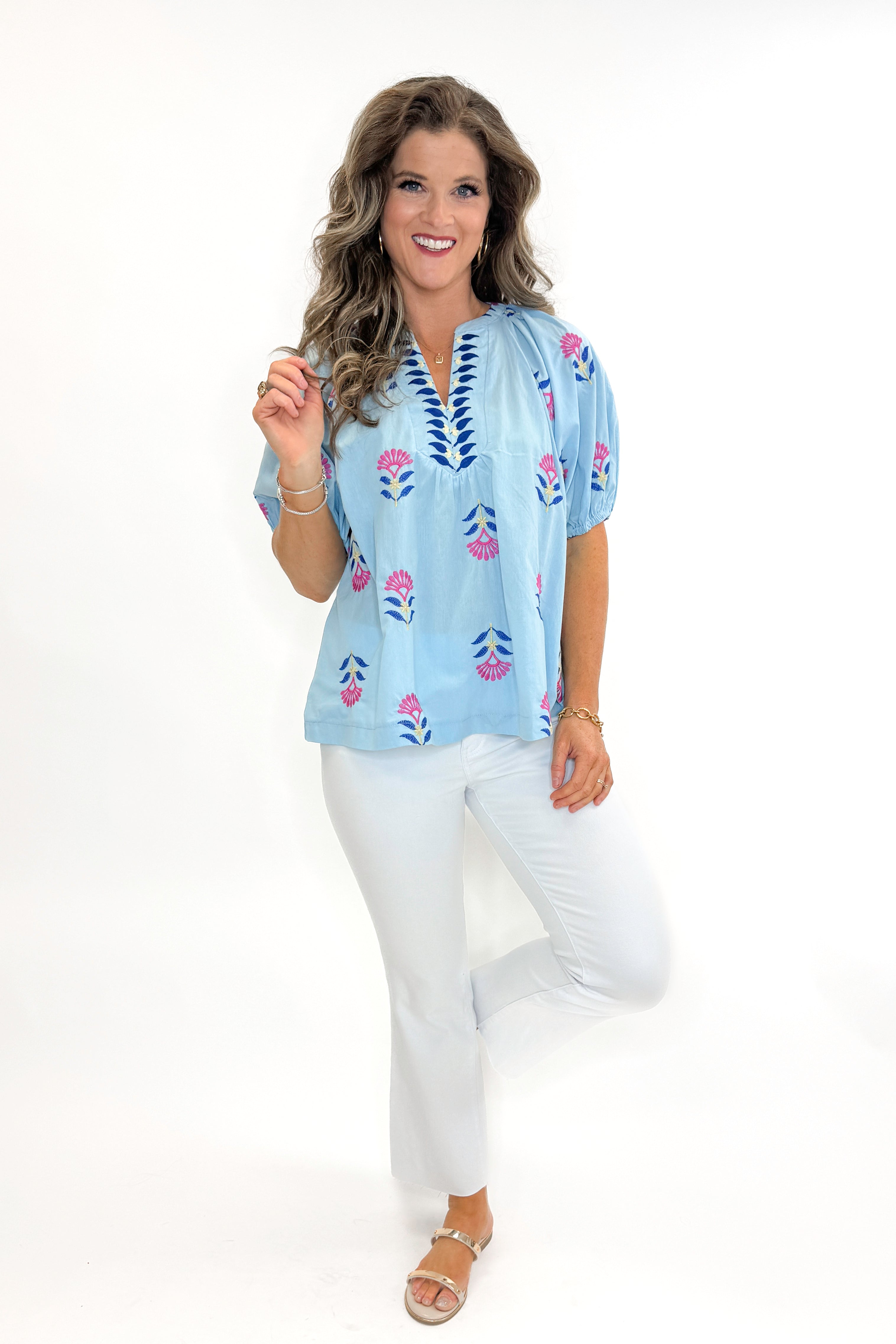 Front view of woman wearing Blue &amp; Multi Floral Embroidered Top with jeans against white studio background.
